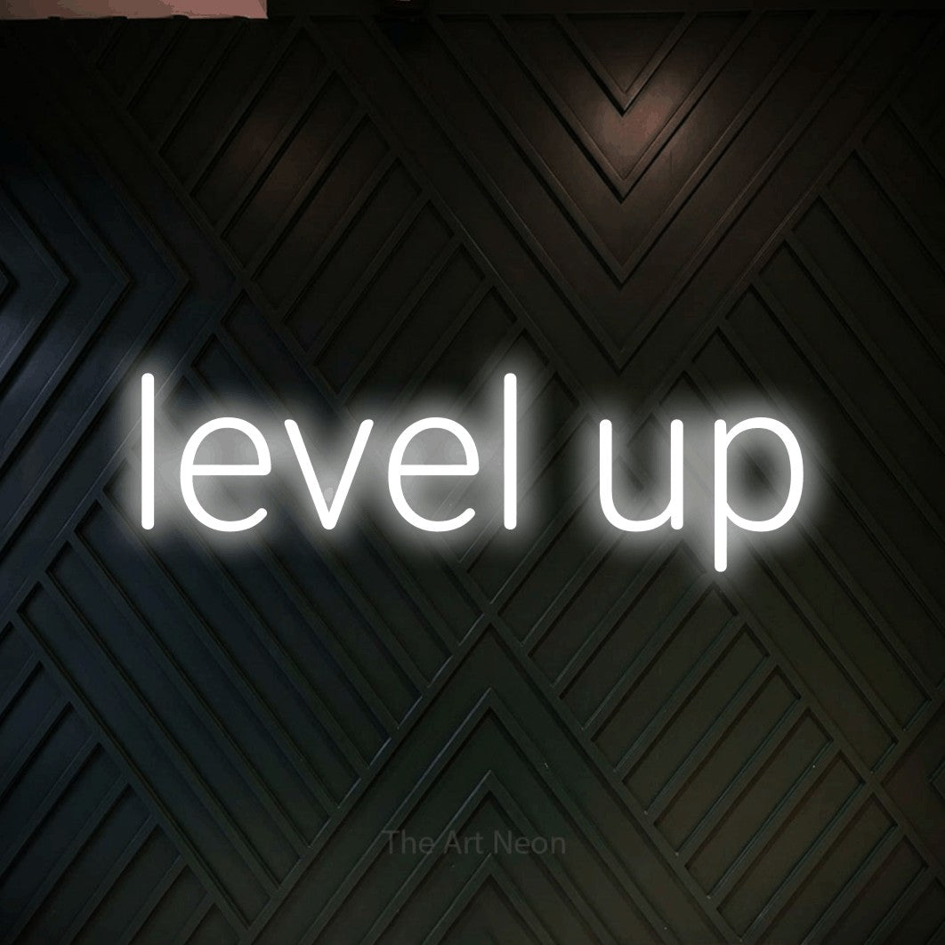 LED neon sign reading “level up”, arranged in a single line.