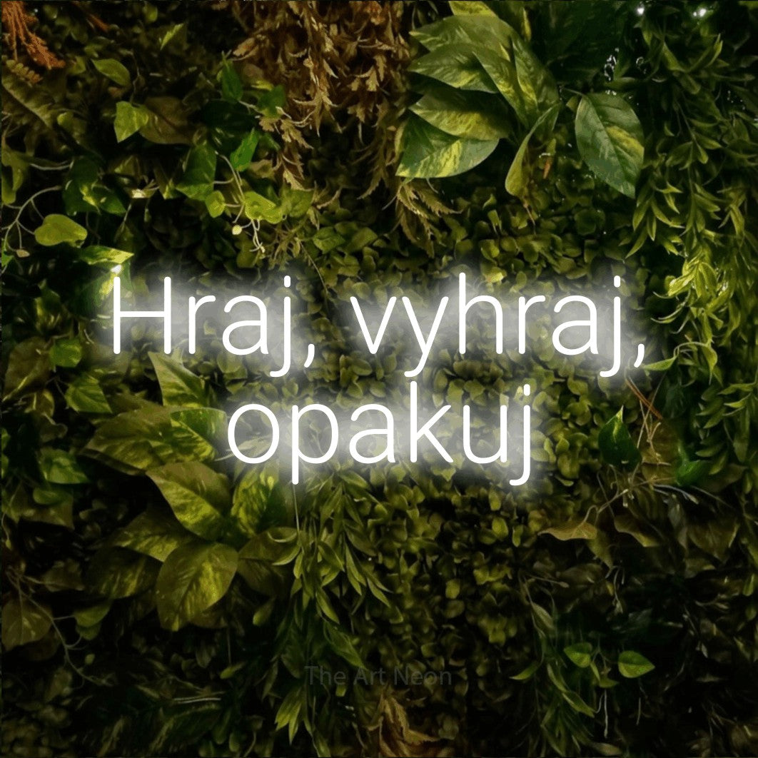 LED neon sign reading “Hraj, vyhraj, opakuj”, arranged in two lines.