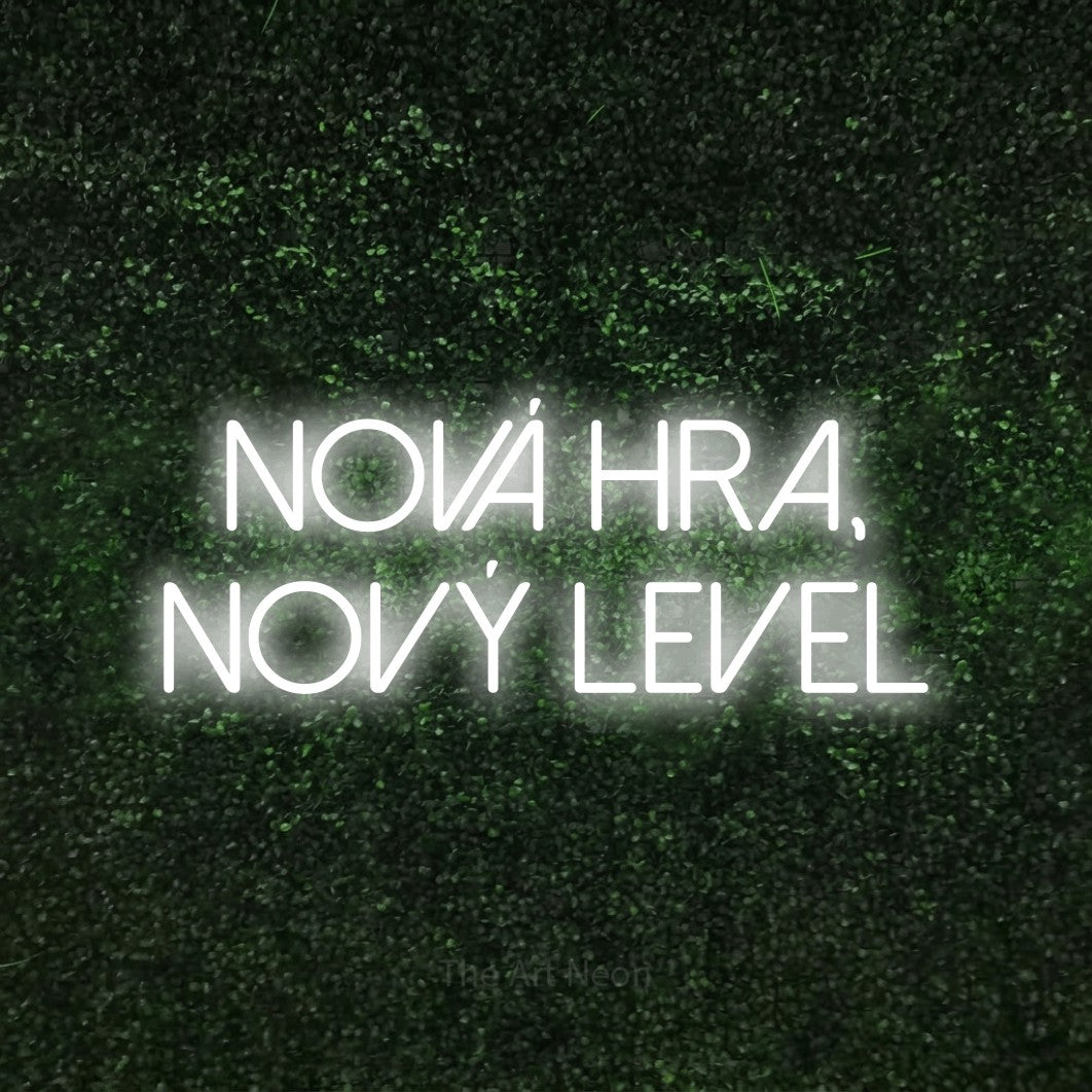 LED neon sign reading “nová hra, nový level”, arranged in two lines.
