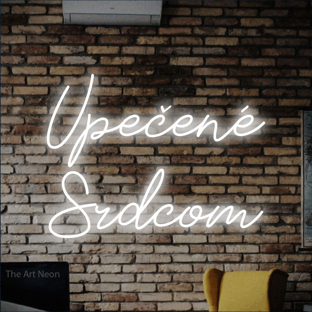 LED neon sign reading “Upečené Srdcom”, arranged in two lines.