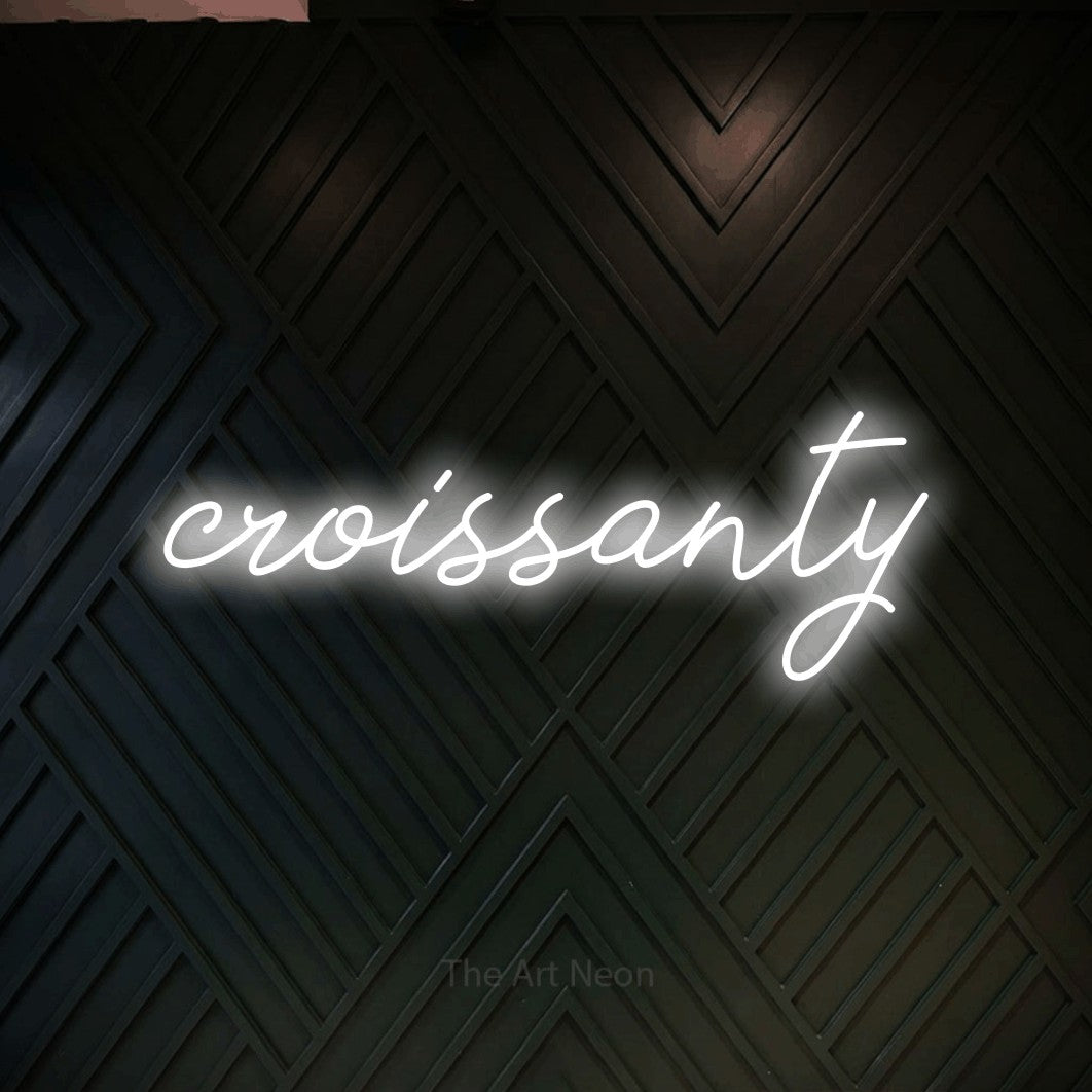 LED neon sign reading “croissanty”, arranged in a single line.