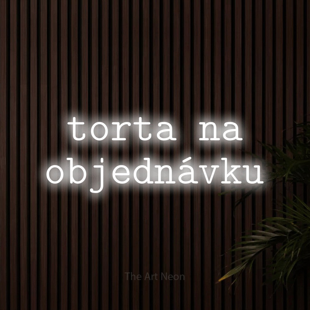 LED neon sign reading “torta na objednávku”, arranged in two lines.