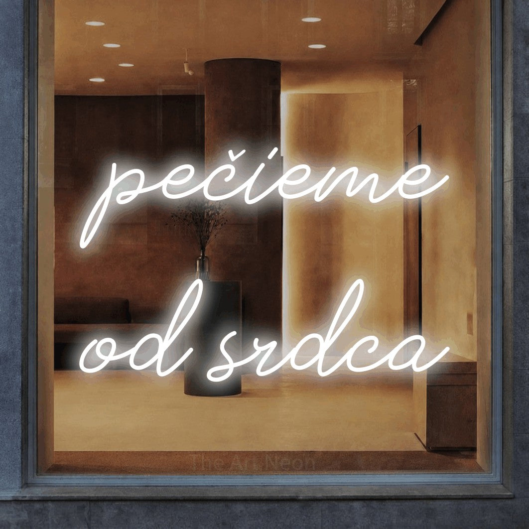 LED neon sign reading “pečieme od srdca”, arranged in two lines.