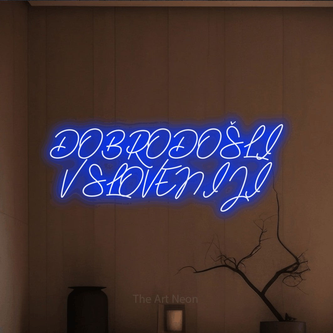 LED neon sign reading “DOBRODOŠLI V SLOVENIJI”, arranged in two lines.
