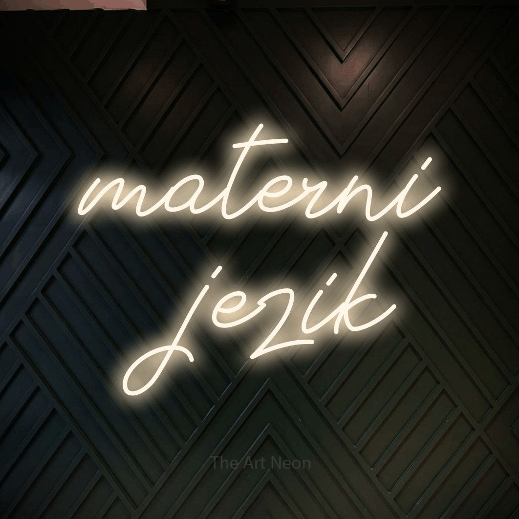 LED neon sign reading “materni jezik”, arranged in two lines.