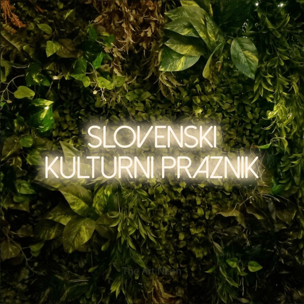 LED neon sign reading “slovenski kulturni praznik”, arranged in two lines.