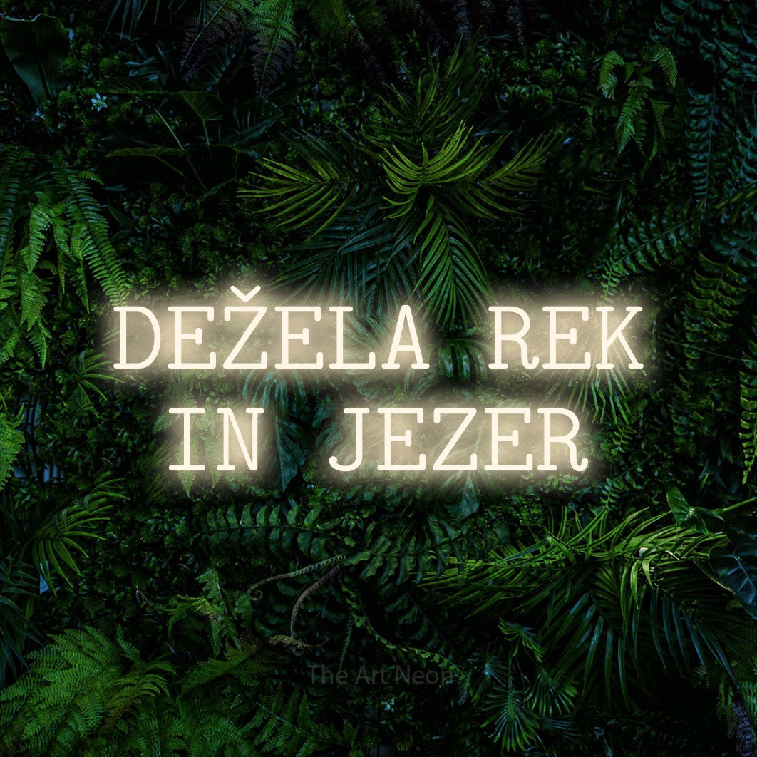 LED neon sign reading “DEŽELA REK IN JEZER”, arranged in two lines.