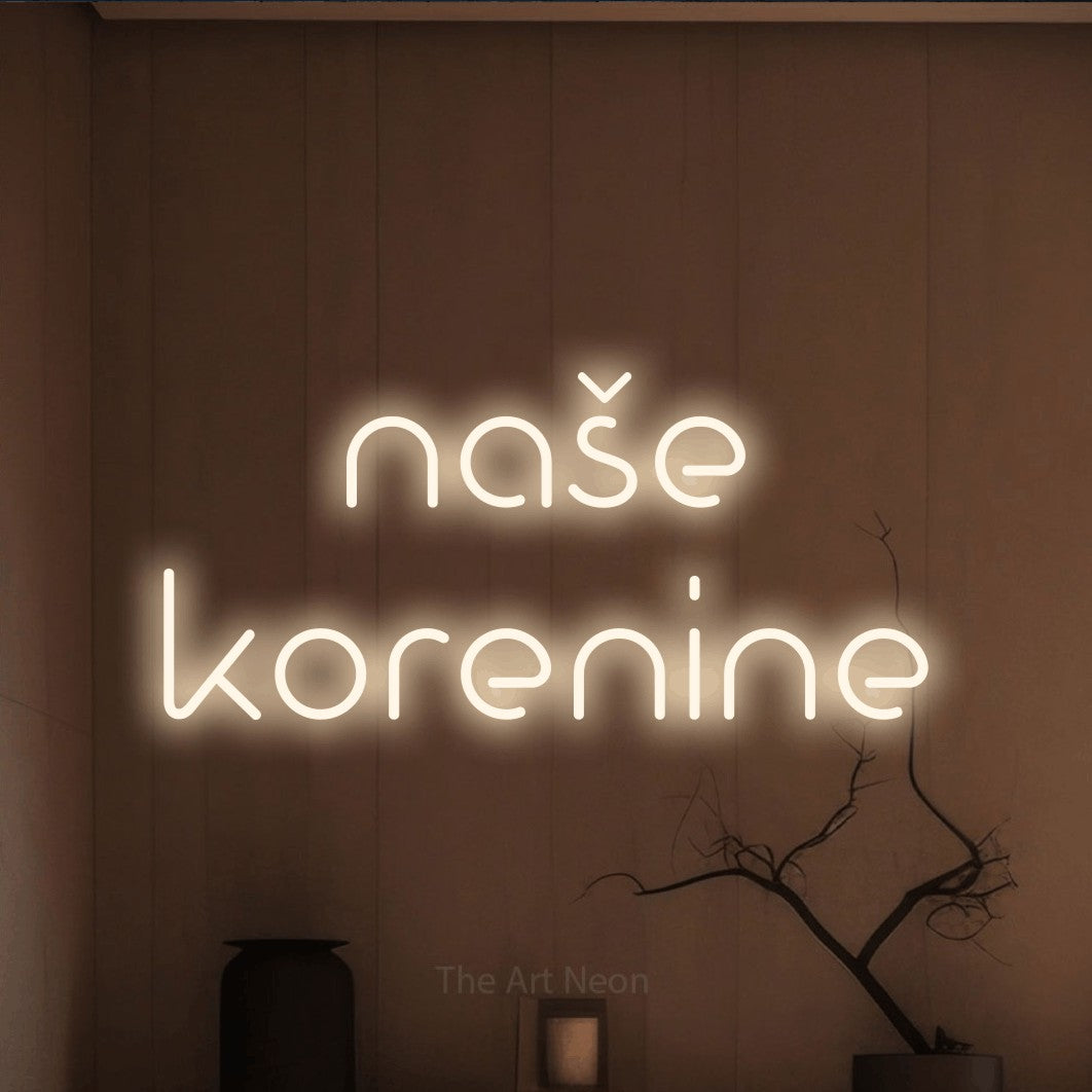 LED neon sign reading “naše korenine”, arranged in two lines.