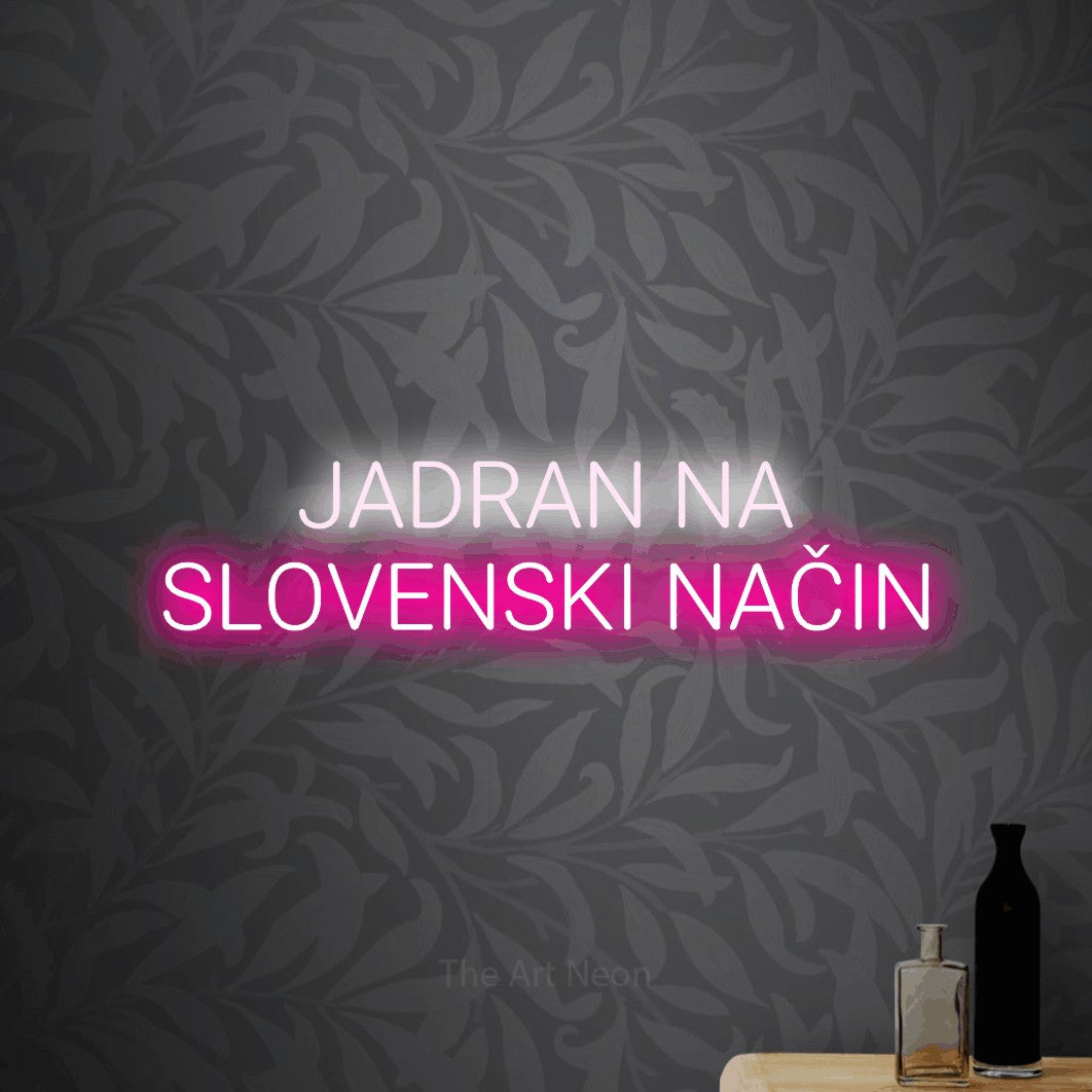 LED neon sign reading “JADRAN NA SLOVENSKI NAČIN”, arranged in two lines.