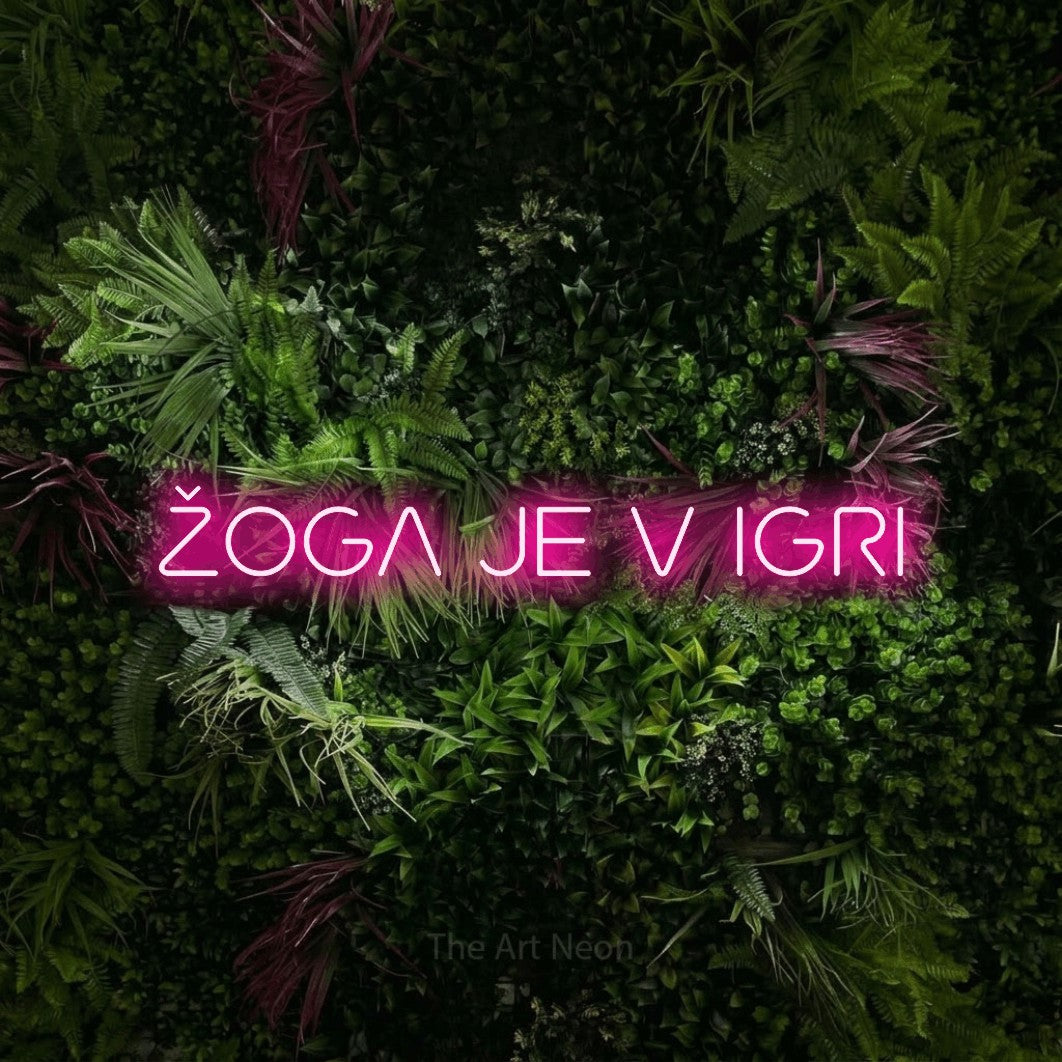 LED neon sign reading “ŽOGA JE V IGRI”, arranged in a single line.