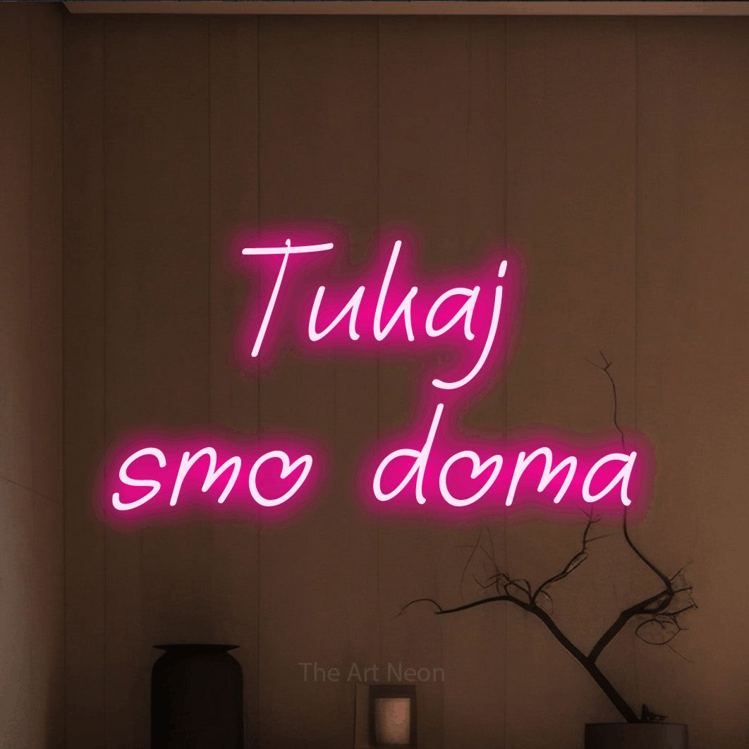 LED neon sign reading “Tukaj smo doma”, arranged in two lines.