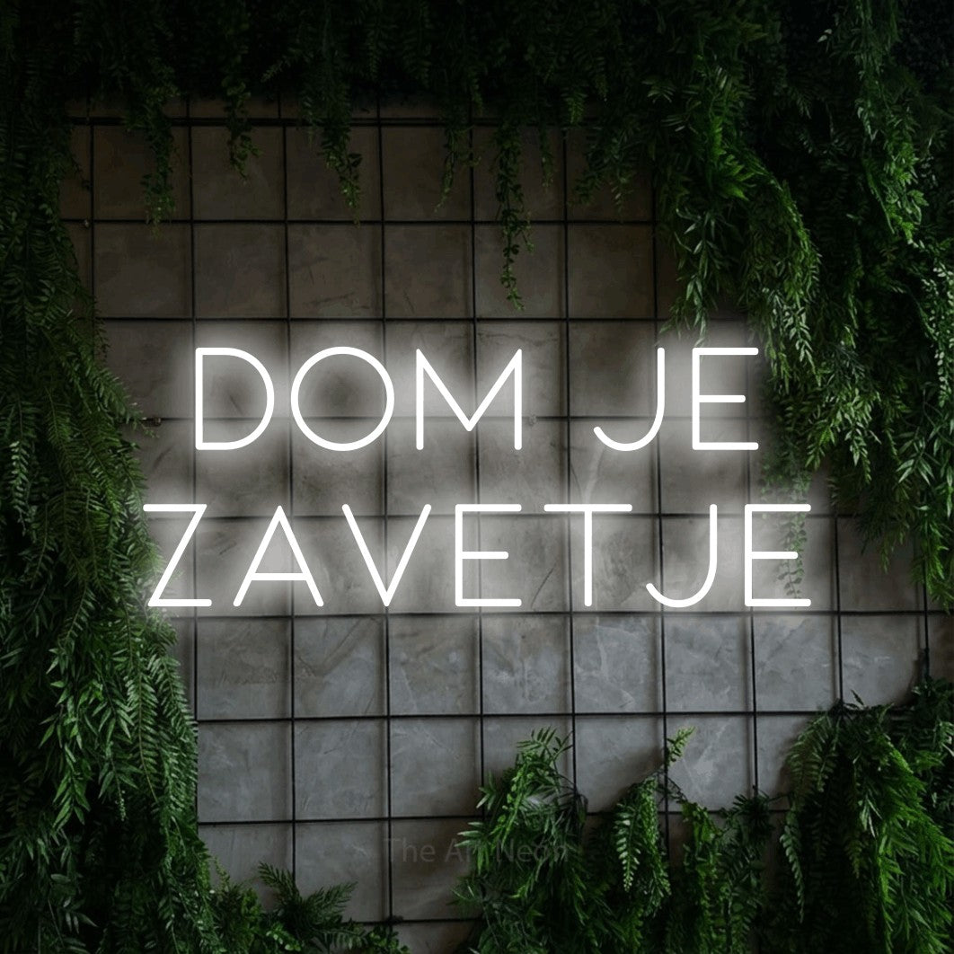 LED neon sign reading “dom je zavetje”, arranged in two lines.