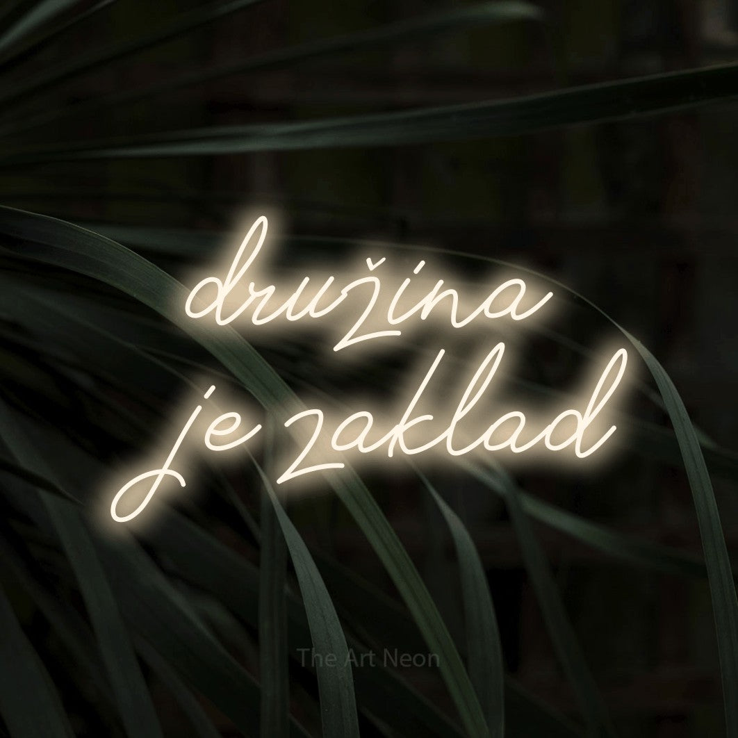 LED neon sign reading “družina je zaklad”, arranged in two lines.