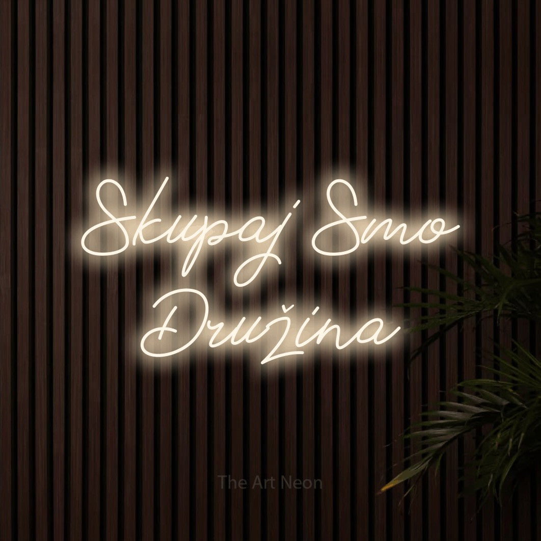 LED neon sign reading “Skupaj Smo Družina”, arranged in two lines.