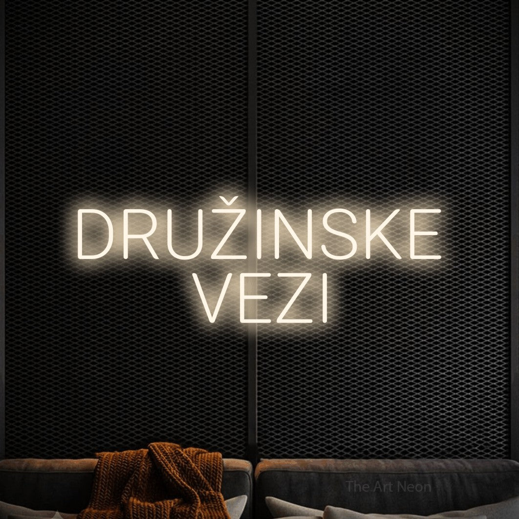 LED neon sign reading “DRUŽINSKE VEZI”, arranged in two lines.