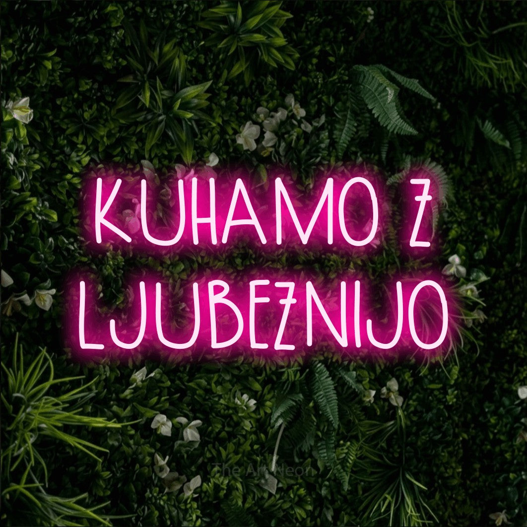 LED neon sign reading “KUHAMO Z LJUBEZNIJO”, arranged in two lines.
