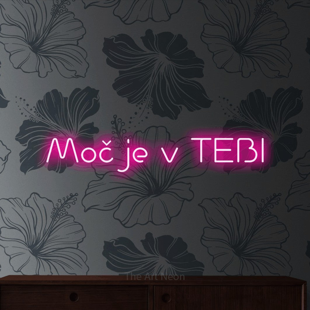 LED neon sign reading “Moč je v TEBI”, arranged in a single line.