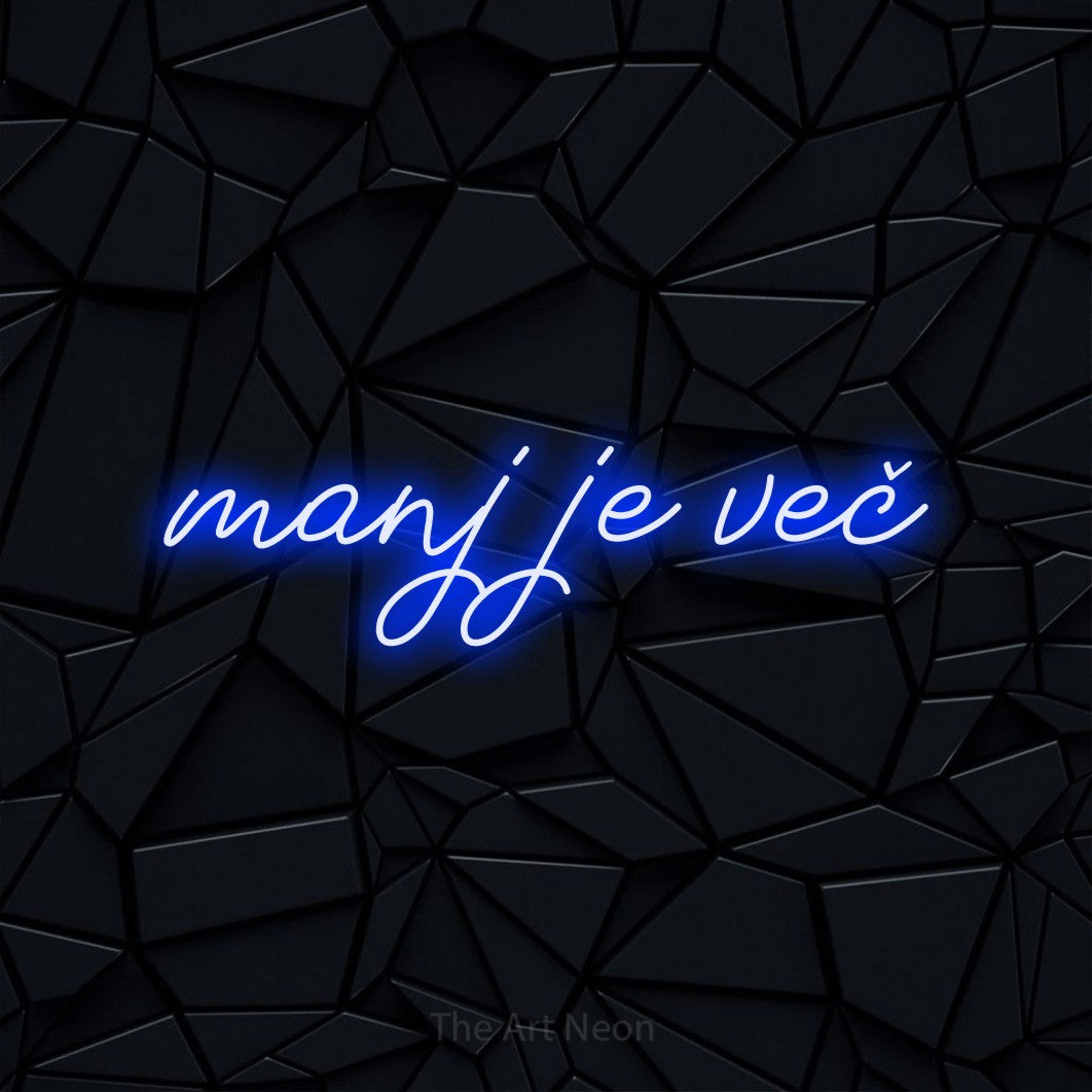 LED neon sign reading “manj je več”, arranged in a single line.
