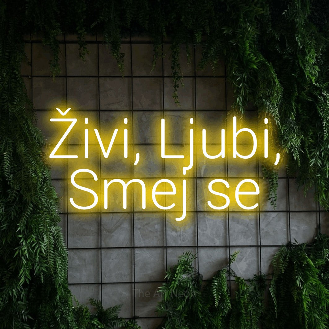 LED neon sign reading “Živi, Ljubi, Smej se”, arranged in two lines.