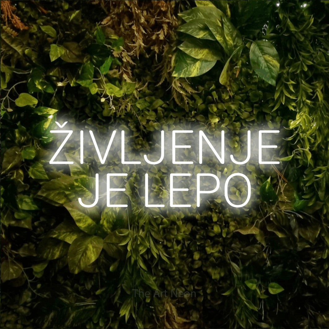 LED neon sign reading “ŽIVLJENJE JE LEPO”, arranged in two lines.