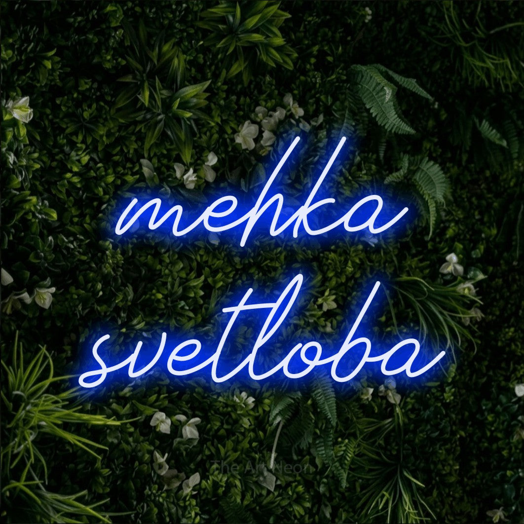 LED neon sign reading “mehka svetloba”, arranged in two lines.
