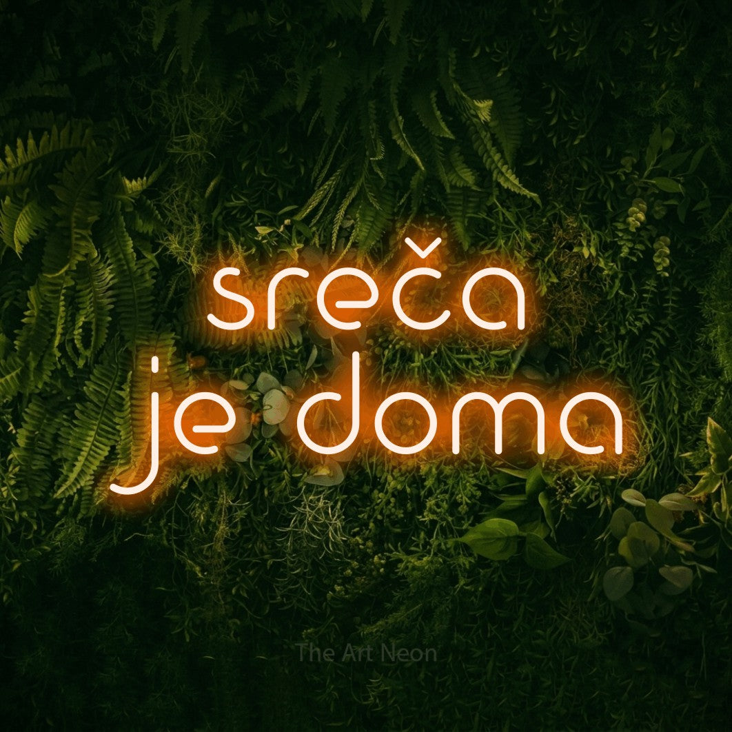 LED neon sign reading “sreča je doma”, arranged in two lines.