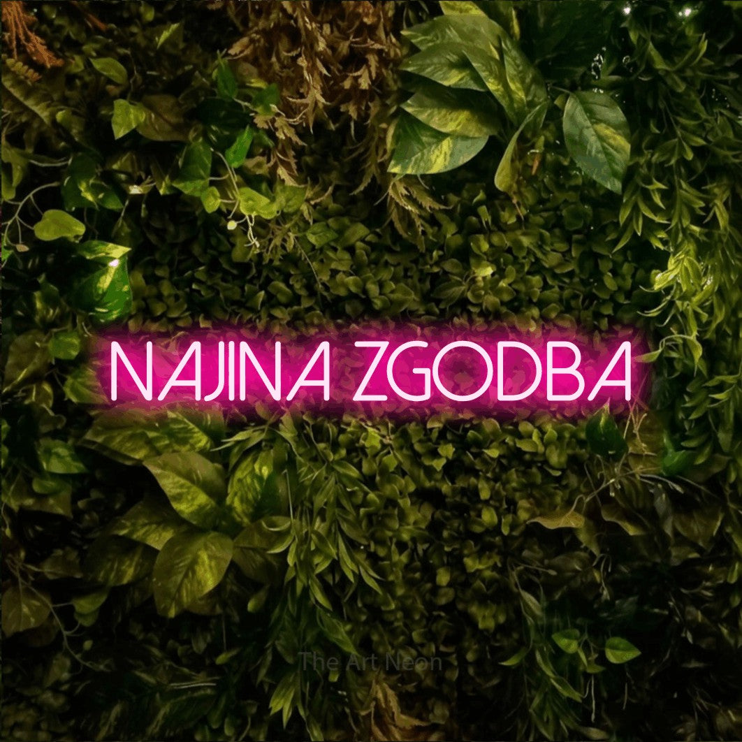 LED neon sign reading “NAJINA Zgodba”, arranged in a single line.