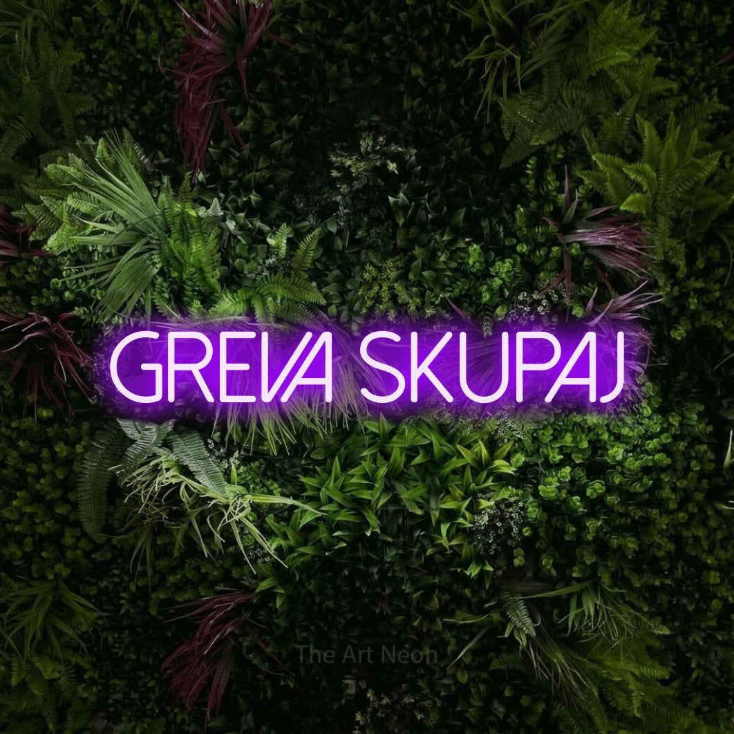LED neon sign reading “GREVA SKUPAJ”, arranged in a single line.