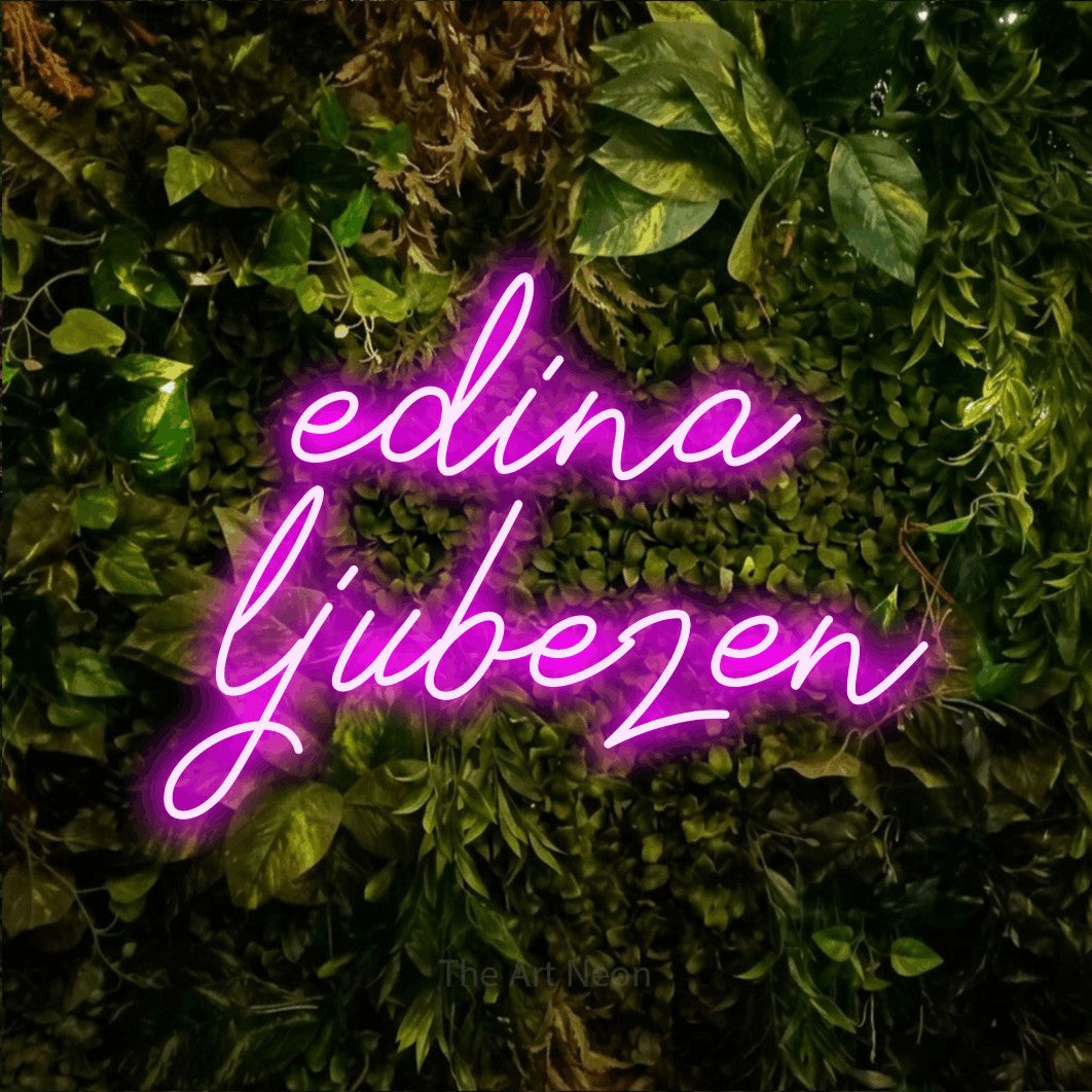 LED neon sign reading “edina ljubezen”, arranged in two lines.