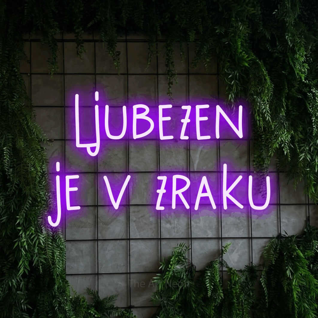 LED neon sign reading “ljubezen je v zraku”, arranged in two lines.