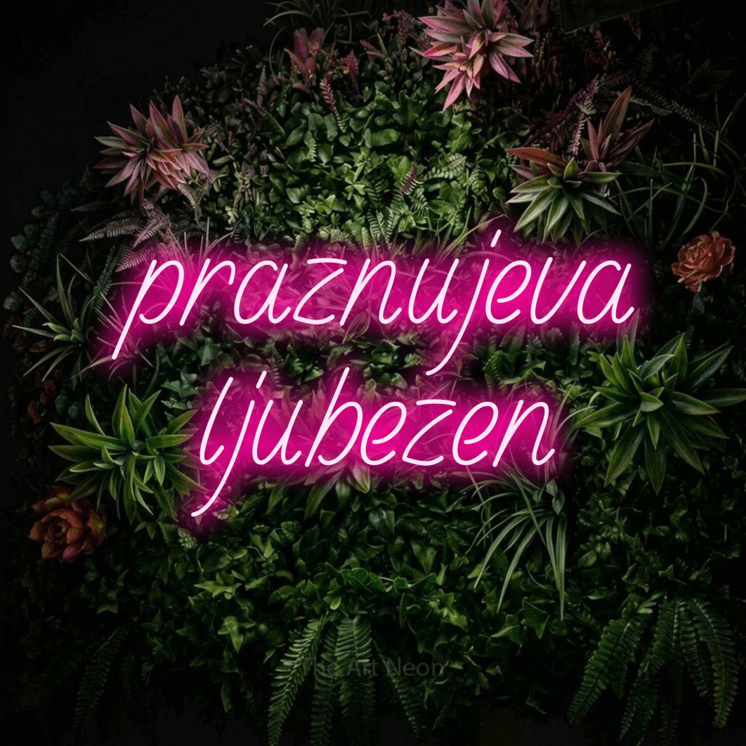 LED neon sign reading “praznujeva ljubezen”, arranged in two lines.