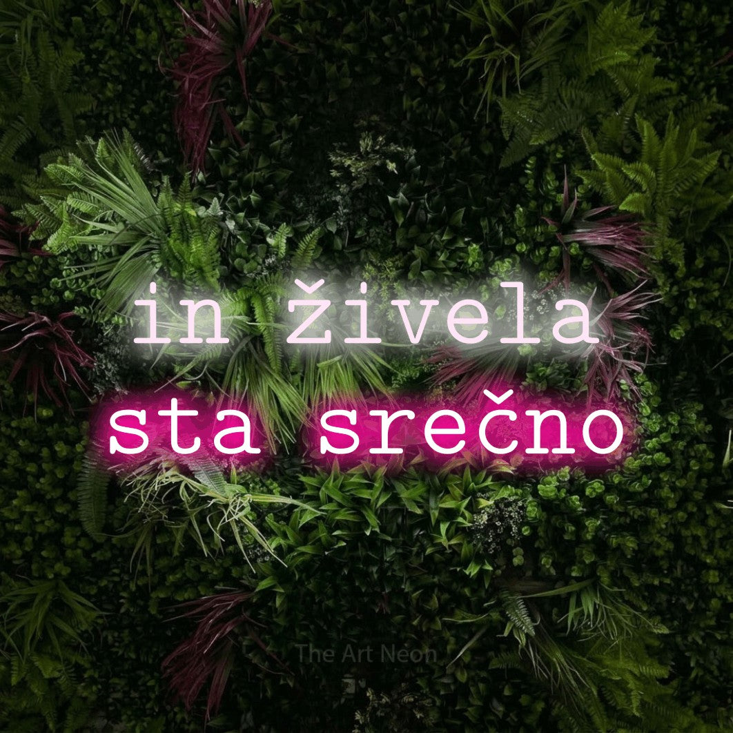 LED neon sign reading “in živela sta srečno”, arranged in two lines.