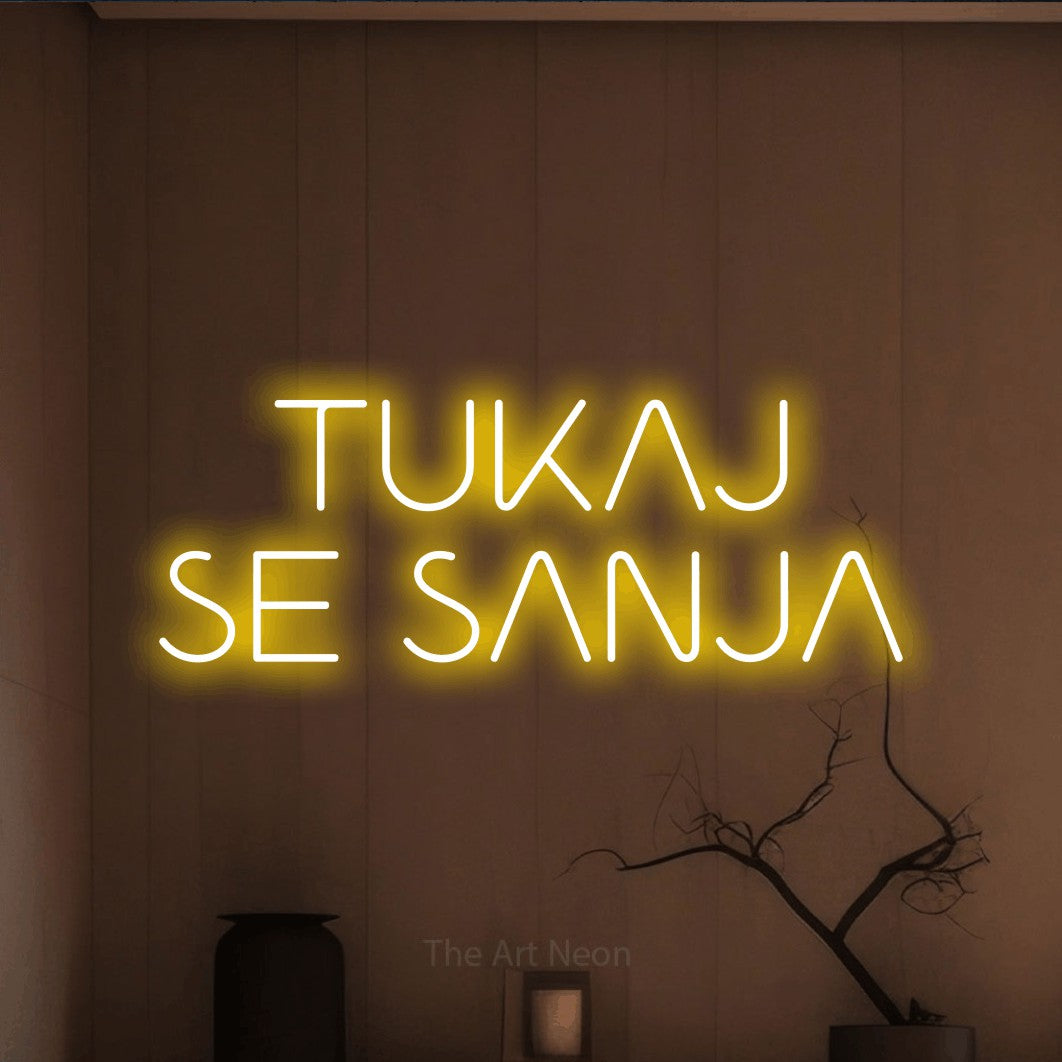 LED neon sign reading “TUKAJ SE SANJA”, arranged in two lines.