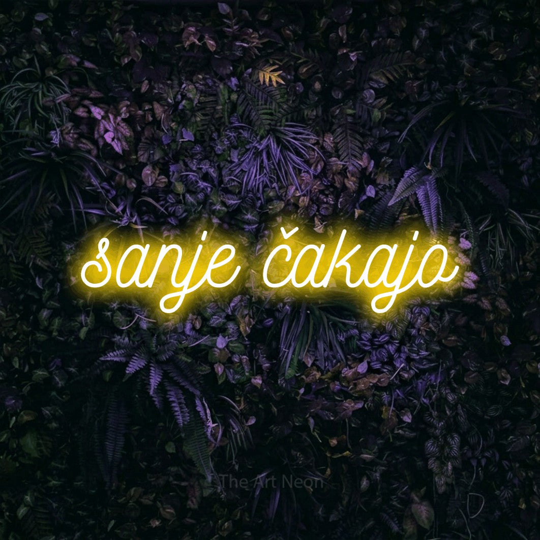 LED neon sign reading “sanje čakajo”, arranged in a single line.