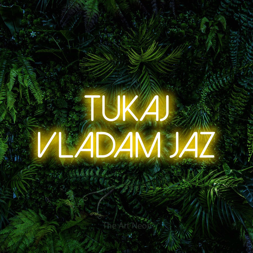 LED neon sign reading “TUKAJ VLADAM JAZ”, arranged in two lines.