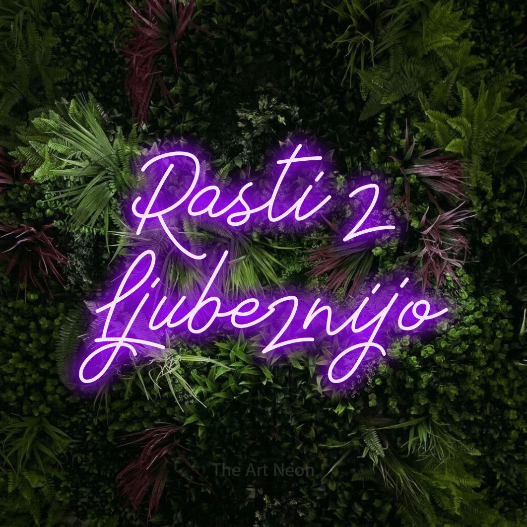 LED neon sign reading “Rasti z Ljubeznijo”, arranged in two lines.