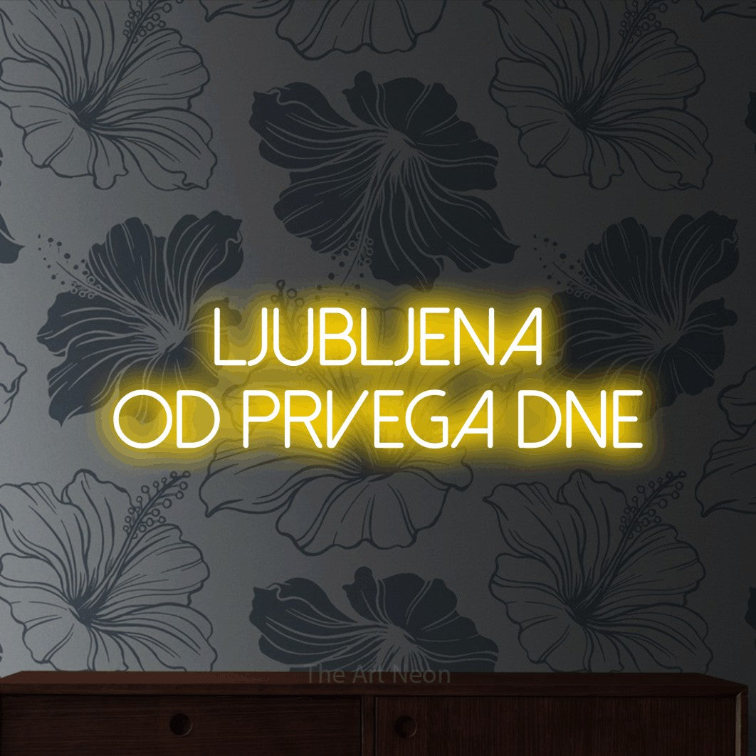 LED neon sign reading “Ljubljena od prvega dne”, arranged in two lines.