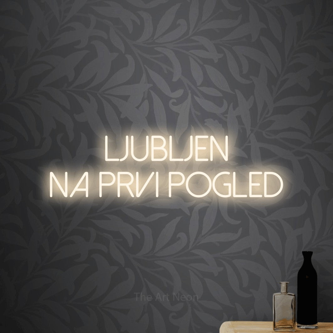 LED neon sign reading “Ljubljen na Prvi Pogled”, arranged in two lines.