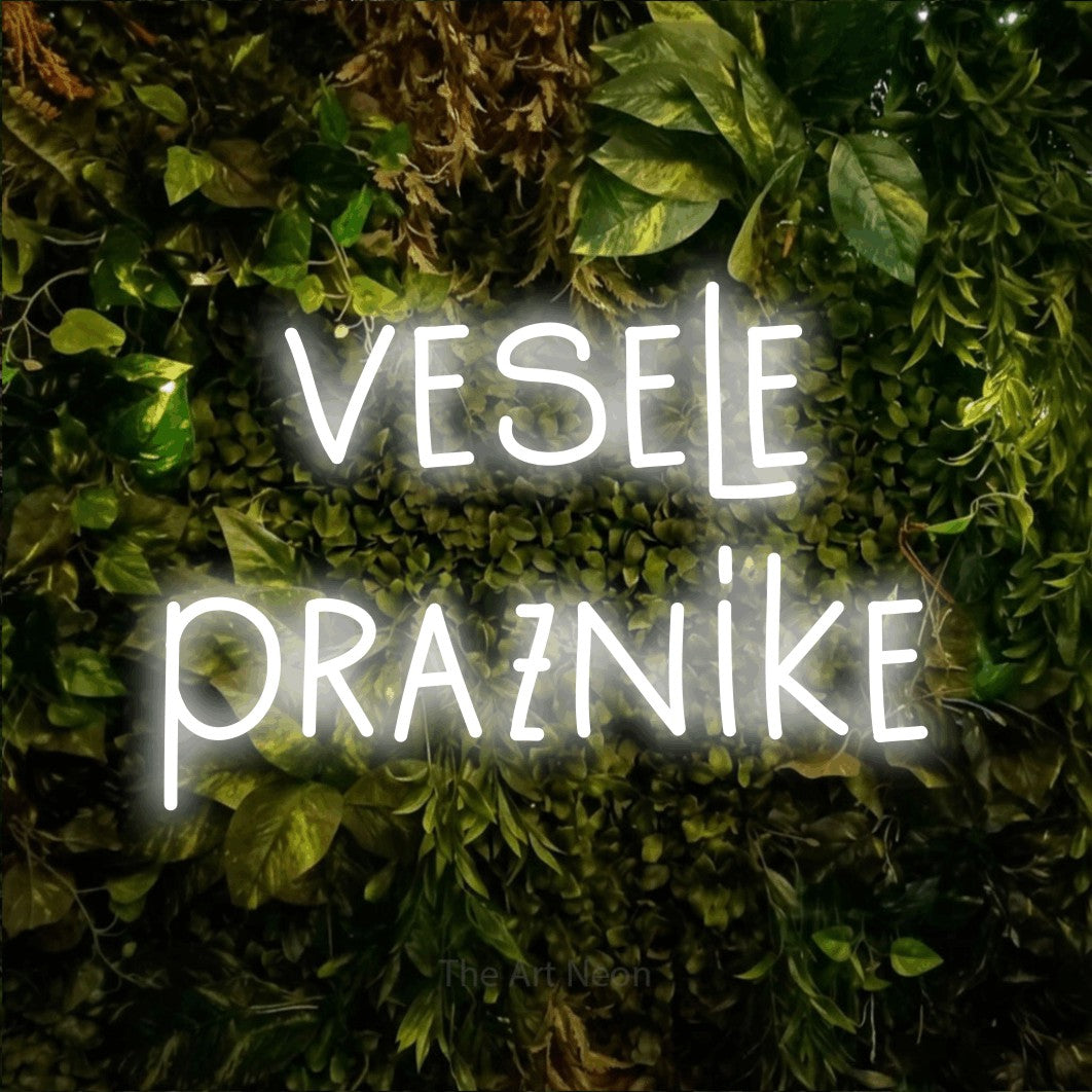 LED neon sign reading “vesele praznike”, arranged in two lines.