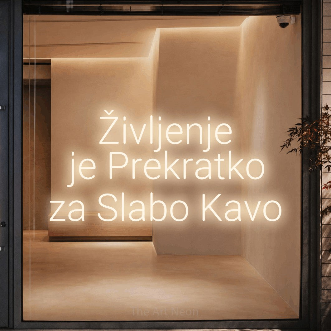 LED neon sign reading “Življenje je Prekratko za Slabo Kavo”, arranged in three lines.