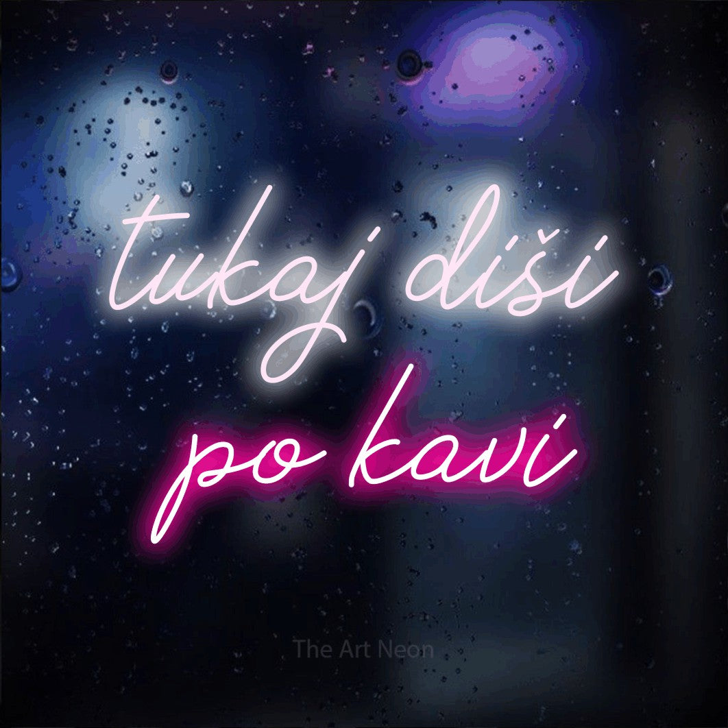 LED neon sign reading “tukaj diši po kavi”, arranged in two lines.
