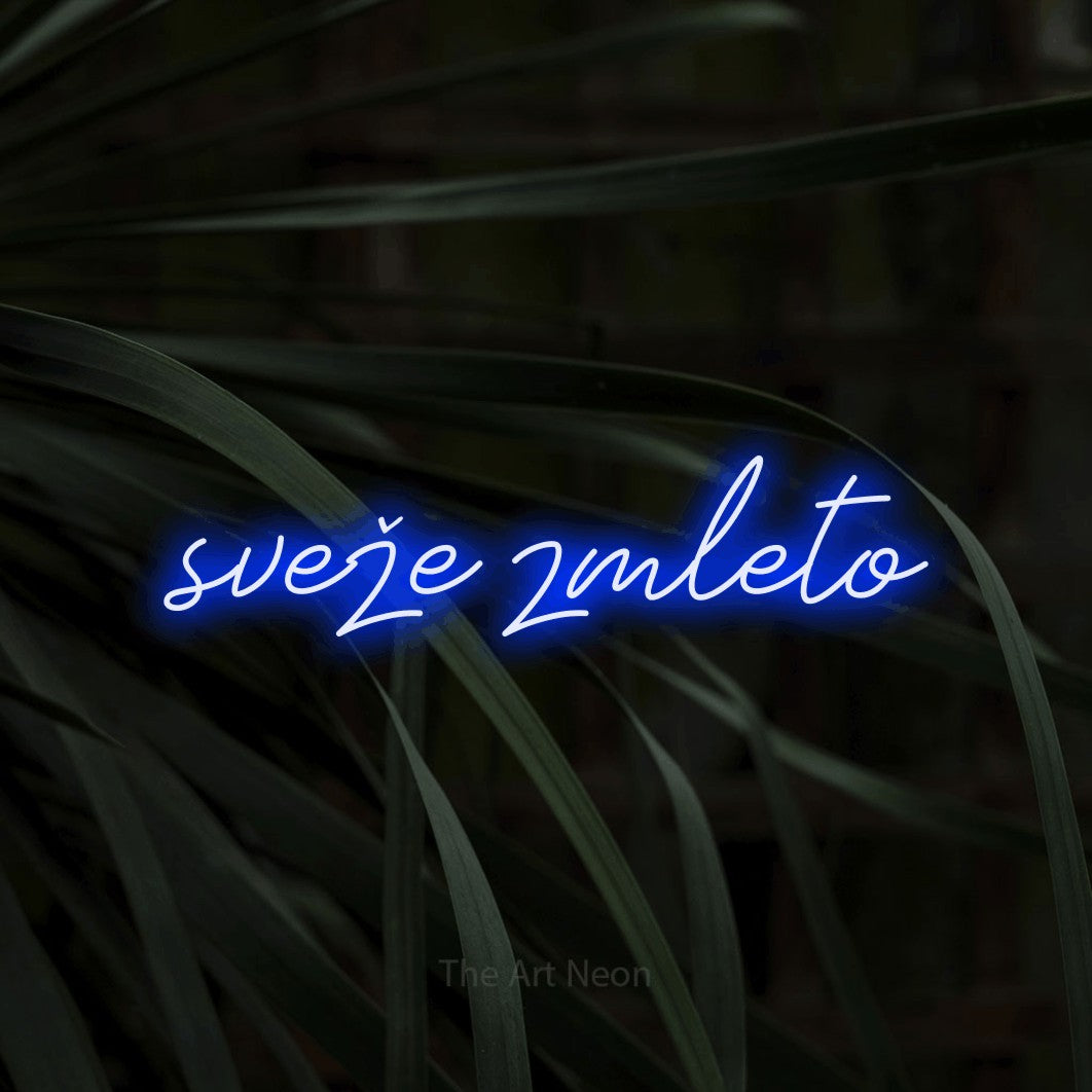 LED neon sign reading “sveže zmleto”, arranged in a single line.
