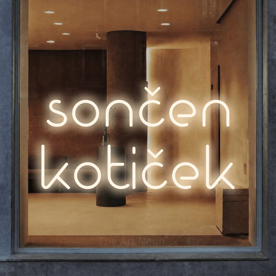 LED neon sign reading “sončen kotiček”, arranged in two lines.
