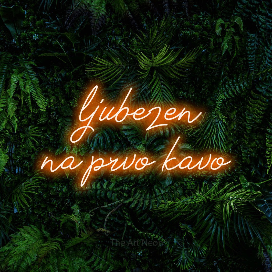 LED neon sign reading “ljubezen na prvo kavo”, arranged in two lines.