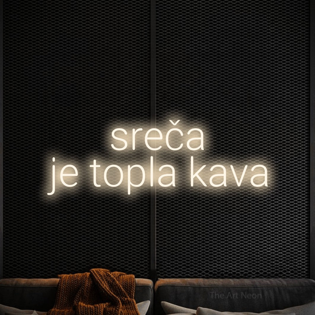 LED neon sign reading “sreča je topla kava”, arranged in two lines.