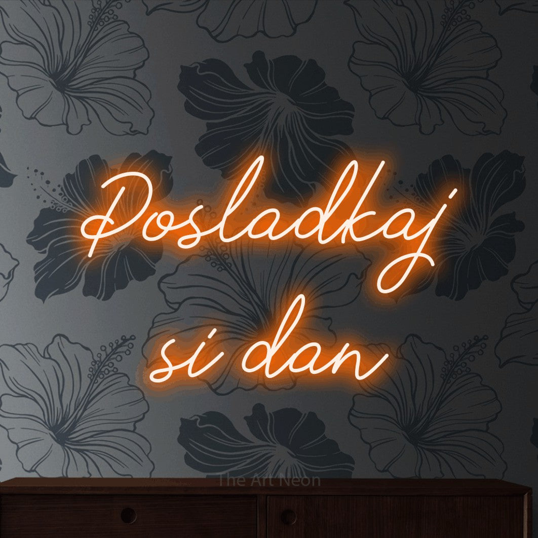LED neon sign reading “Posladkaj si dan”, arranged in two lines.