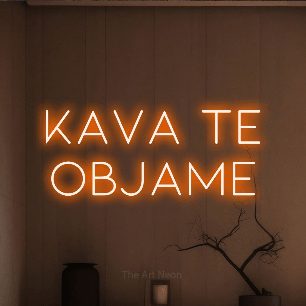 LED neon sign reading “Kava Te OBJAME”, arranged in two lines.