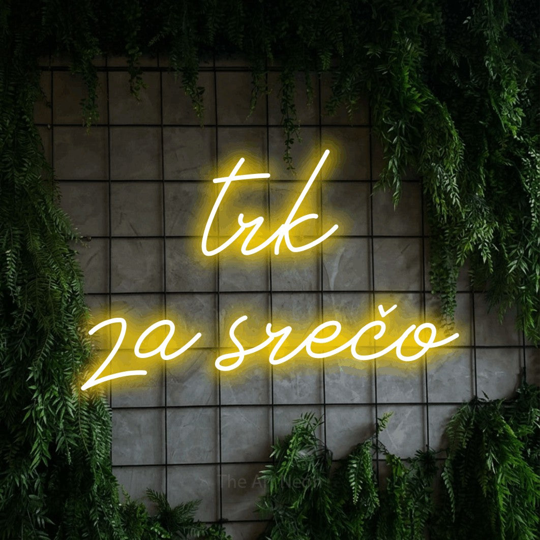 LED neon sign reading “trk za srečo”, arranged in two lines.
