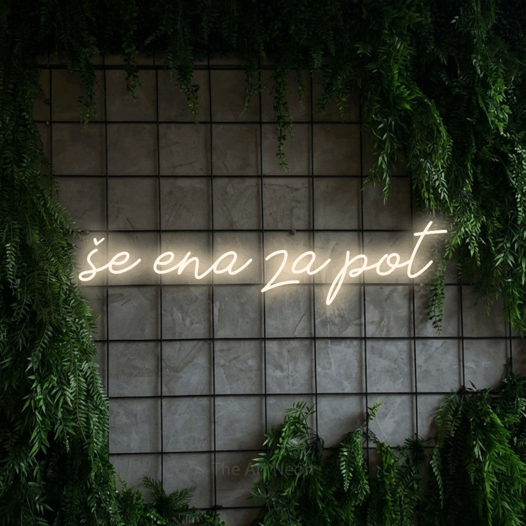 LED neon sign reading “še ena za pot”, arranged in a single line.