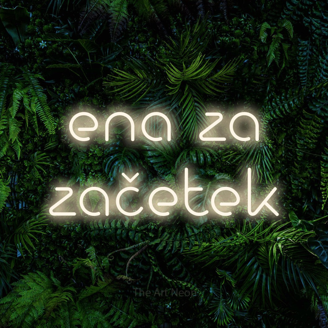 LED neon sign reading “ena za začetek”, arranged in two lines.